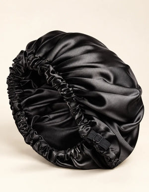 Black BELARO double-layer satin sleep bonnet with elastic edge on a cream background