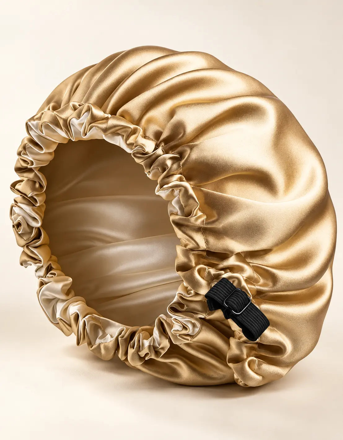 Champagne gold BELARO double-layer satin sleep bonnet on a cream background